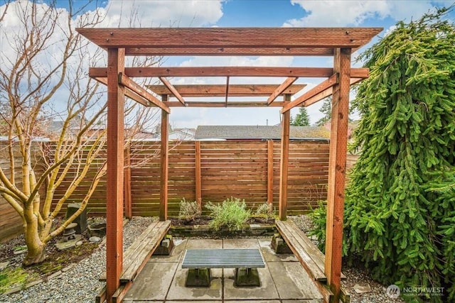 view of patio / terrace featuring a pergola and fence