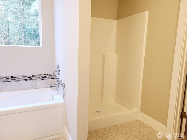 full bath featuring a shower stall and a bath