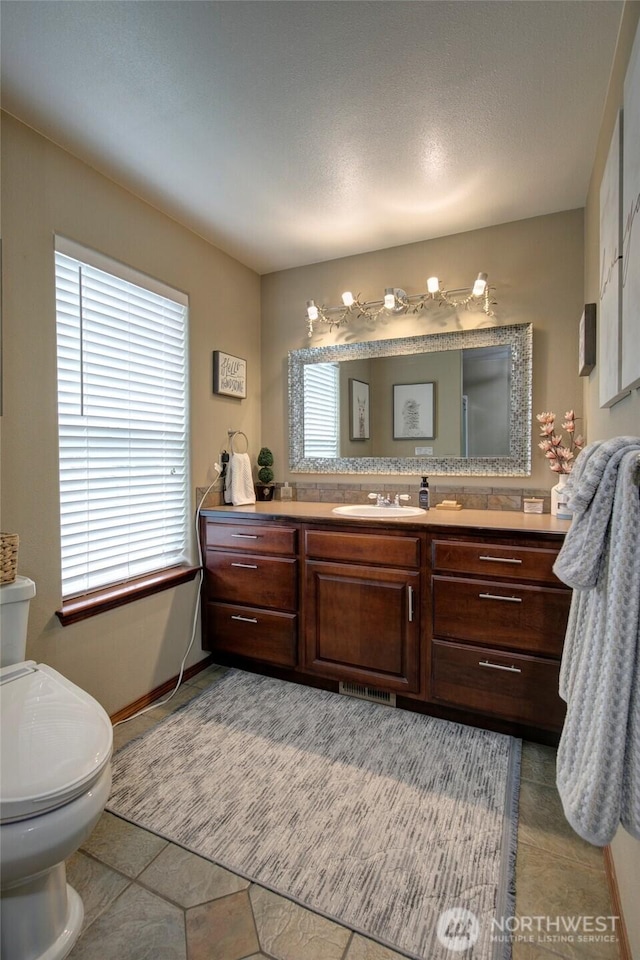 bathroom featuring toilet and vanity