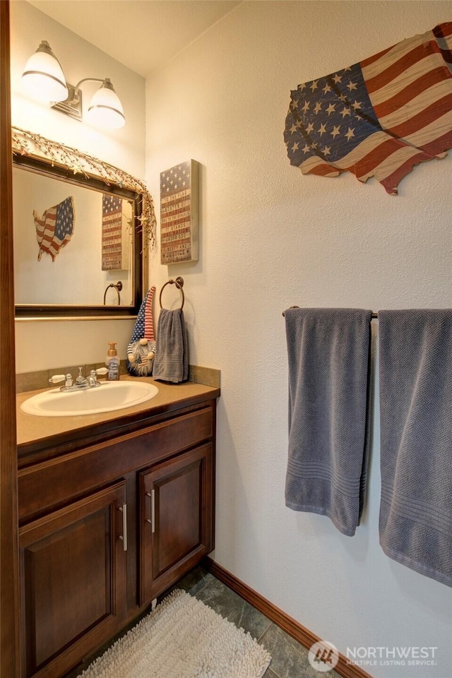 bathroom with vanity and baseboards