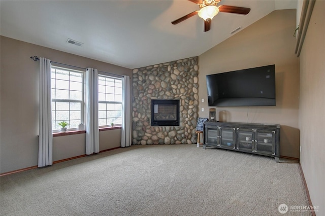 unfurnished living room with visible vents, lofted ceiling, carpet, and ceiling fan