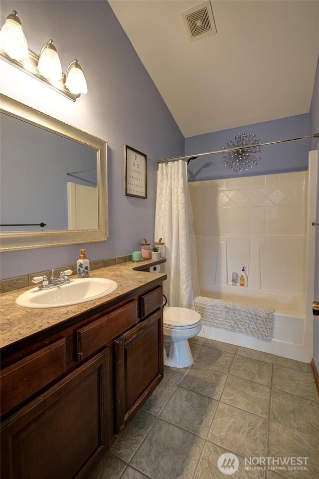 bathroom featuring vanity, visible vents, lofted ceiling, shower / bath combo with shower curtain, and toilet