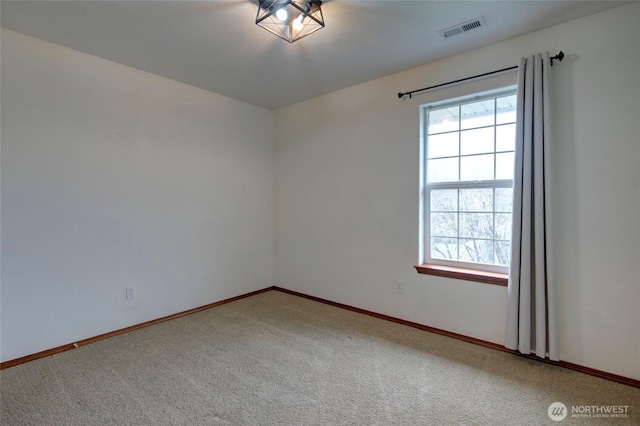 unfurnished room with carpet flooring, baseboards, and visible vents