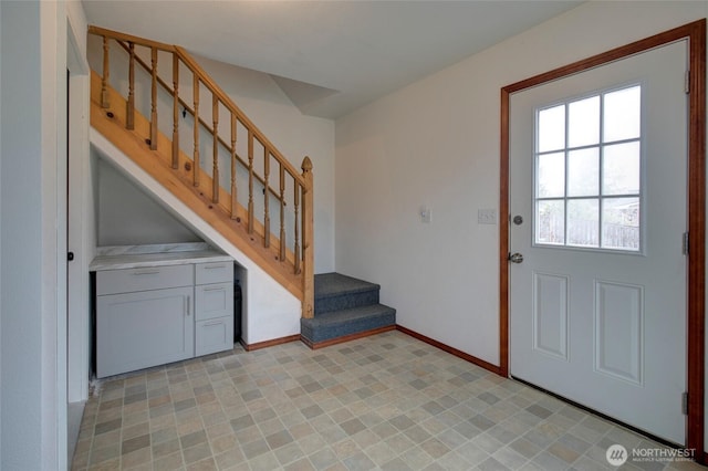 entrance foyer with baseboards and stairs