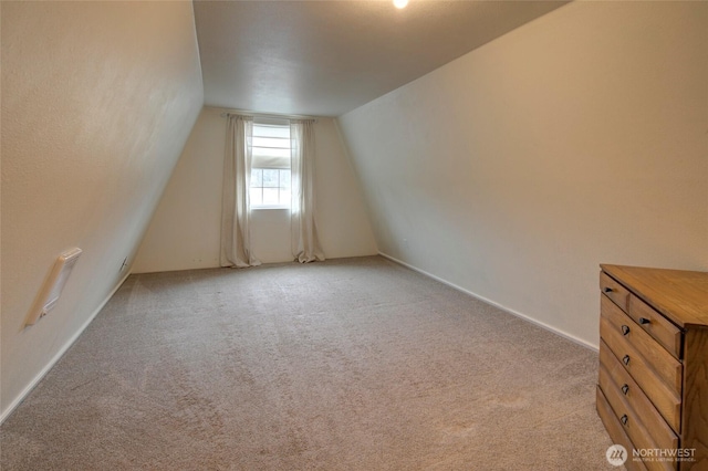 bonus room featuring light carpet and lofted ceiling