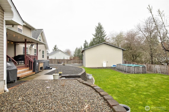 view of yard featuring a fenced in pool, a patio area, and fence