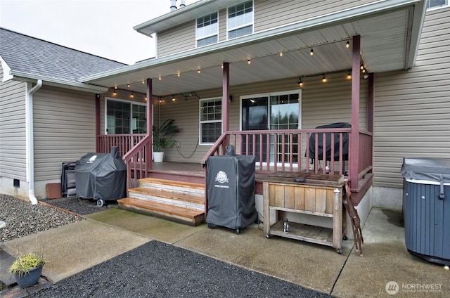 exterior space with a porch and a shingled roof