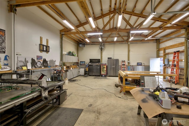 garage featuring a workshop area and metal wall