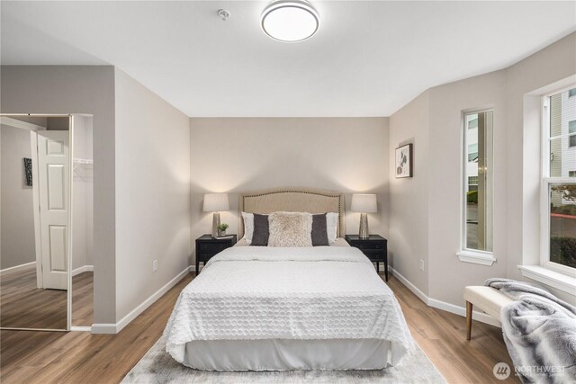 bedroom featuring baseboards and wood finished floors