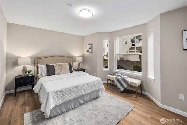 bedroom featuring baseboards and wood finished floors