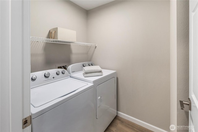 washroom featuring laundry area, wood finished floors, independent washer and dryer, and baseboards