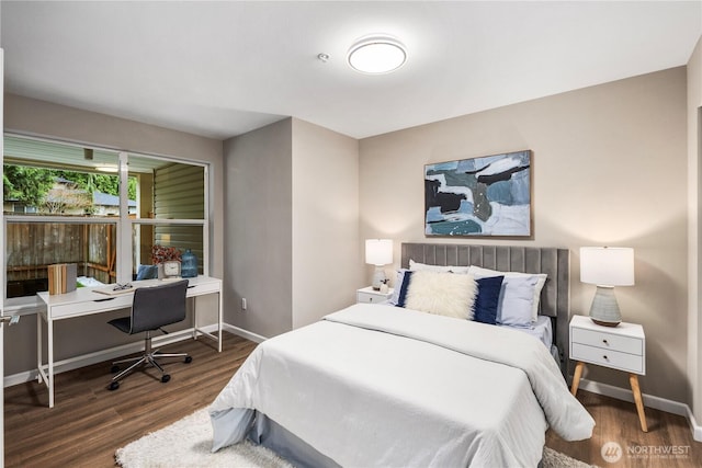 bedroom with wood finished floors and baseboards