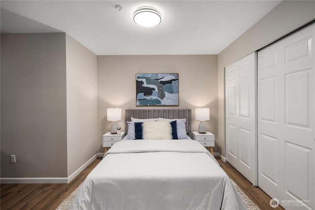 bedroom featuring dark wood-style floors, a closet, and baseboards