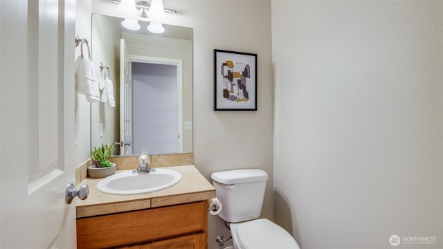 half bathroom featuring toilet and vanity