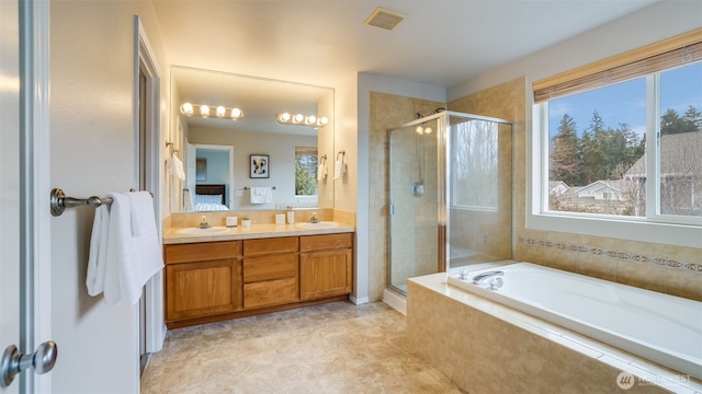 bathroom featuring double vanity, visible vents, a stall shower, and a sink