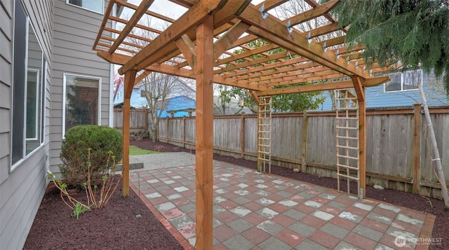 view of patio / terrace featuring a pergola and fence