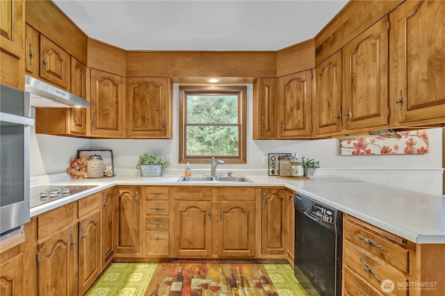 kitchen with under cabinet range hood, black appliances, brown cabinetry, and a sink