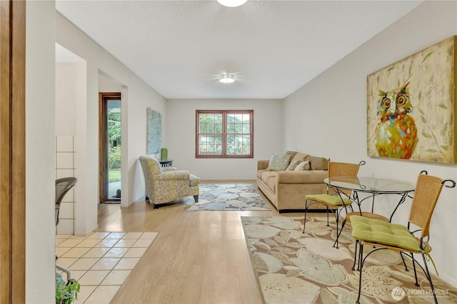 living area with a textured ceiling and wood finished floors