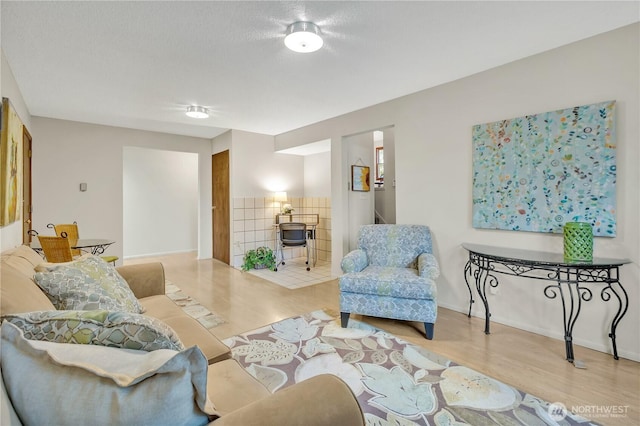 living room with wood finished floors and baseboards