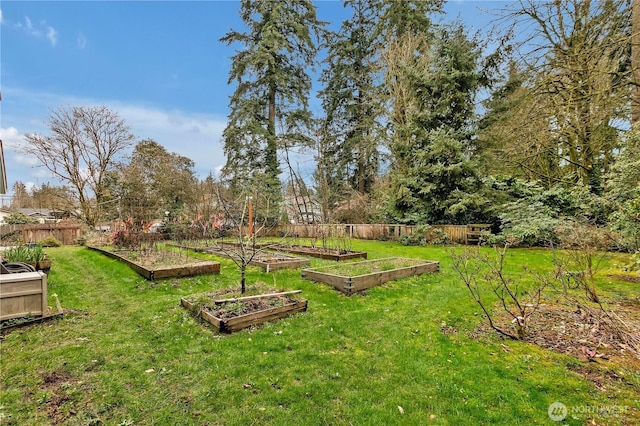 view of yard featuring a vegetable garden and fence