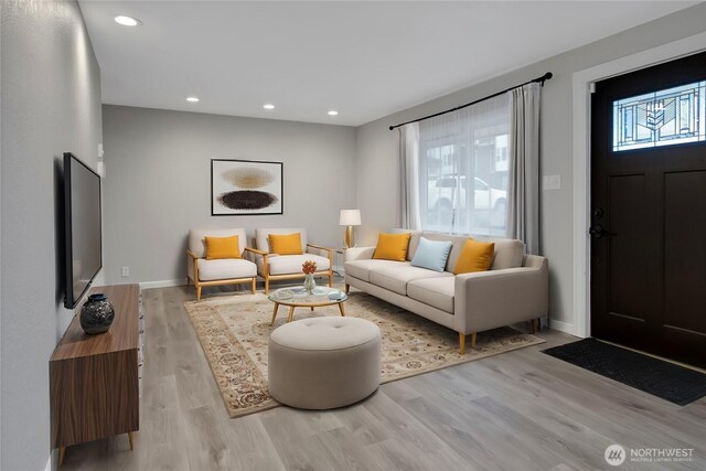 living area featuring recessed lighting, wood finished floors, and baseboards