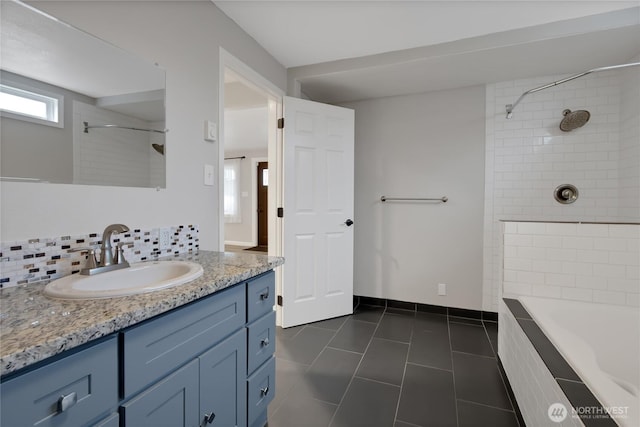 full bathroom with tile patterned floors, vanity, and baseboards