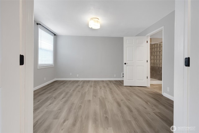 unfurnished room featuring light wood-style flooring and baseboards