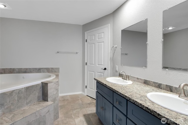 full bath with double vanity, a garden tub, baseboards, and a sink