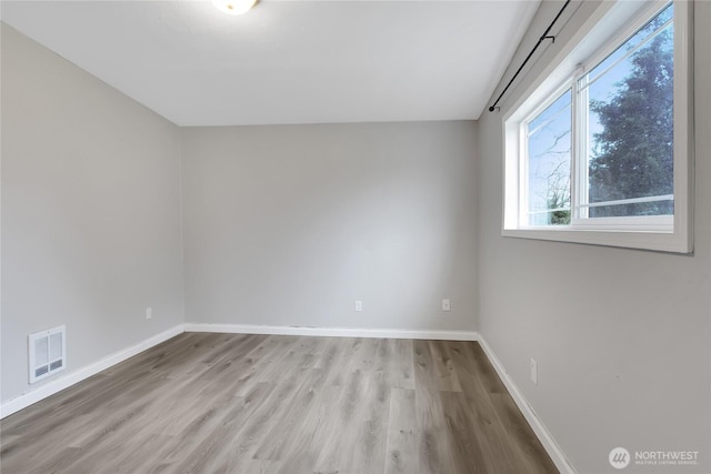 interior space featuring visible vents, light wood-style flooring, and baseboards