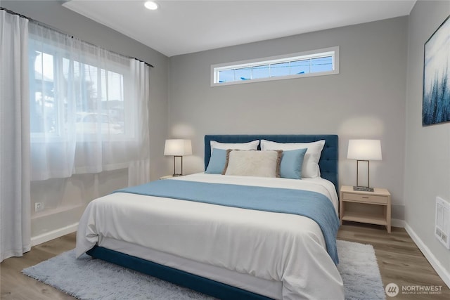 bedroom with visible vents, recessed lighting, wood finished floors, and baseboards