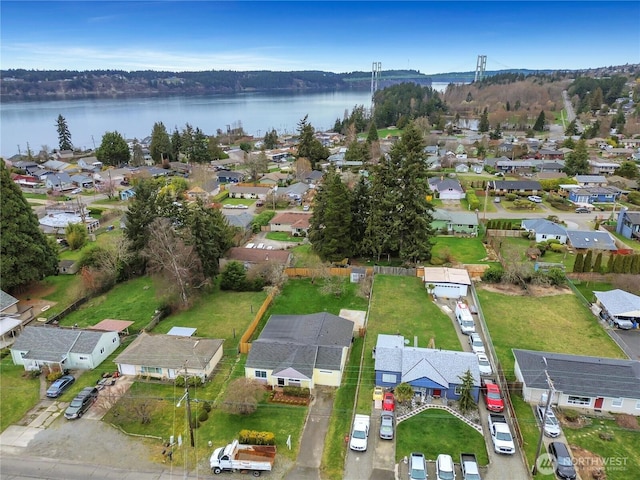 drone / aerial view with a residential view and a water view