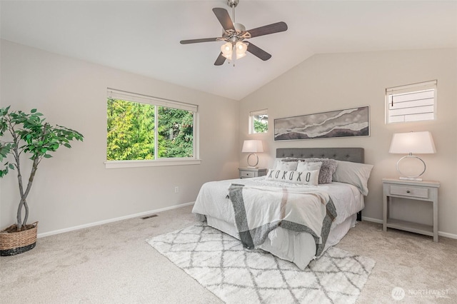 carpeted bedroom with visible vents, ceiling fan, baseboards, and lofted ceiling