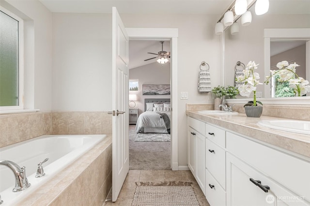 bathroom featuring double vanity, a healthy amount of sunlight, a bath, and ensuite bathroom