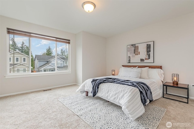 bedroom featuring visible vents, baseboards, and carpet