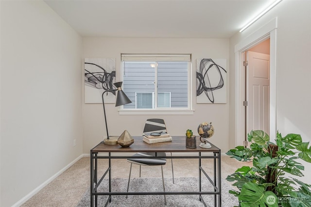 carpeted home office featuring baseboards