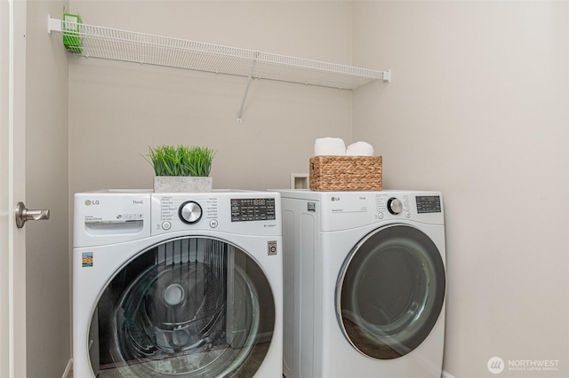 clothes washing area with washing machine and dryer and laundry area