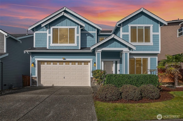 view of front of home with board and batten siding, driveway, and a garage