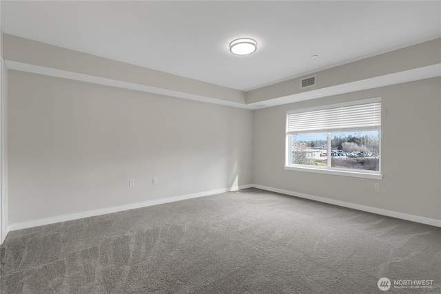 spare room with visible vents, baseboards, and carpet floors