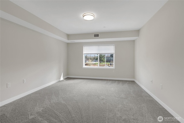 carpeted empty room with visible vents and baseboards