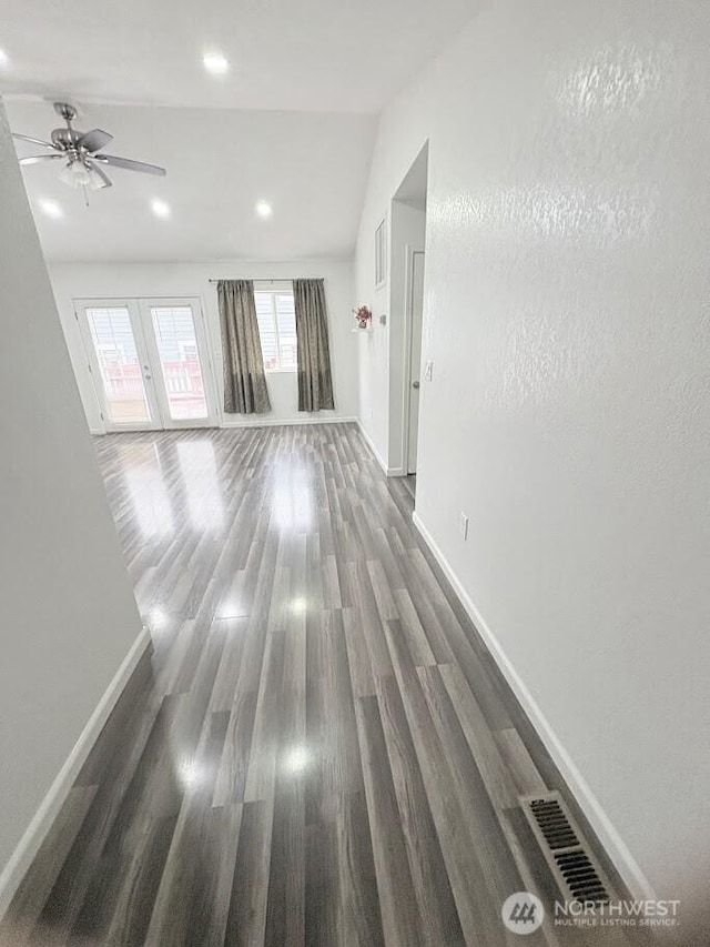 unfurnished living room featuring recessed lighting, baseboards, wood finished floors, and a ceiling fan