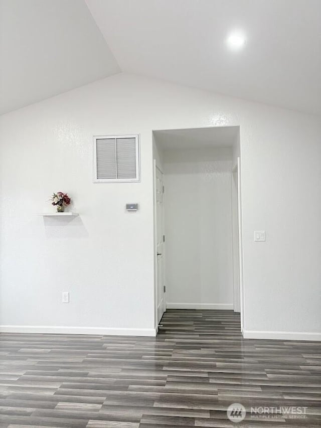 hall with vaulted ceiling, baseboards, and wood finished floors