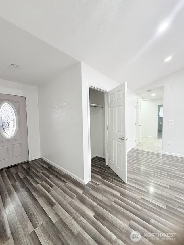 entrance foyer featuring baseboards and wood finished floors