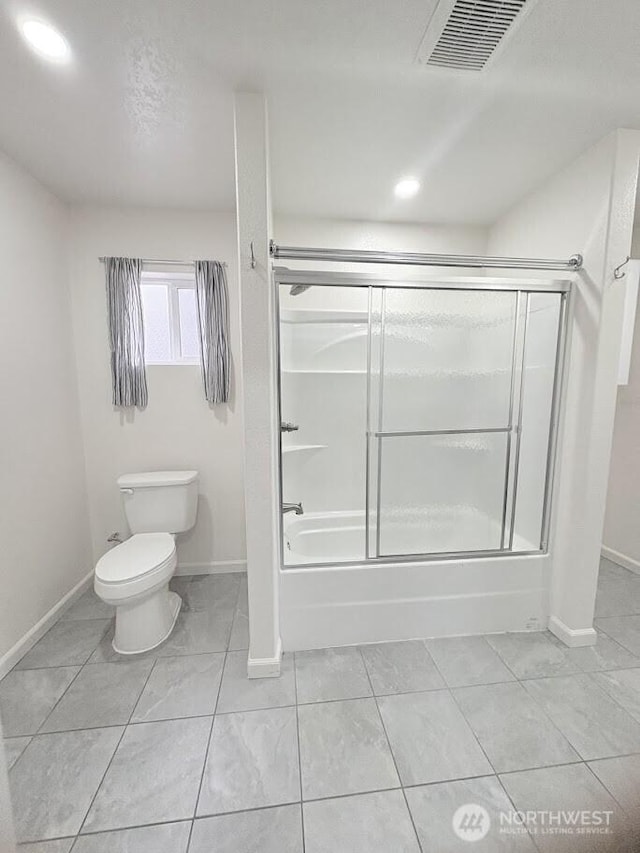 bathroom featuring combined bath / shower with glass door, visible vents, baseboards, and toilet