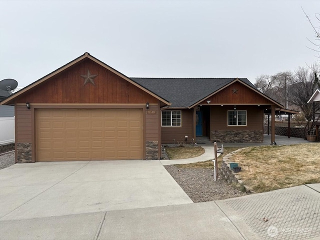 view of front facade featuring stone siding, an attached garage, roof with shingles, and driveway