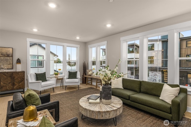 living room featuring recessed lighting, a healthy amount of sunlight, and wood finished floors