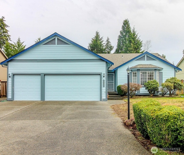 single story home featuring a garage and driveway