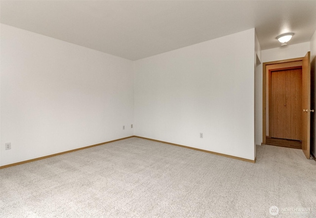 empty room with light carpet and baseboards