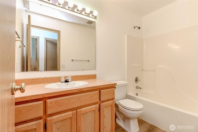 bathroom with bathing tub / shower combination, visible vents, toilet, and vanity