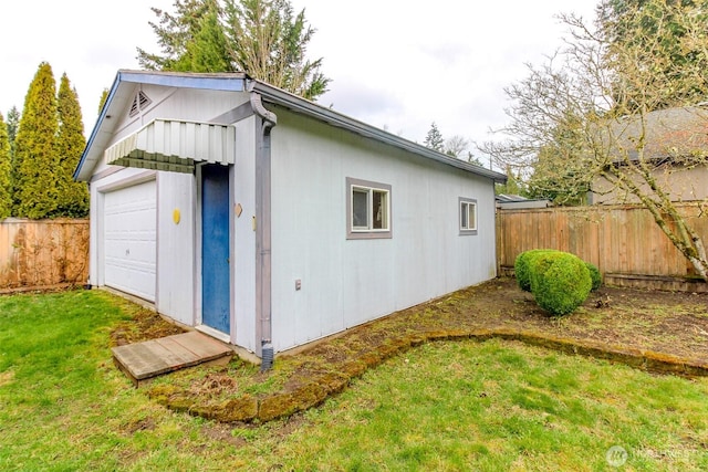 view of outbuilding featuring fence