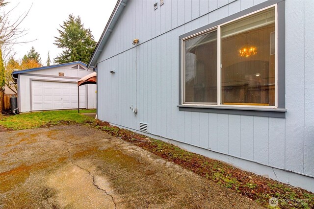 view of property exterior featuring crawl space, an outbuilding, and a garage